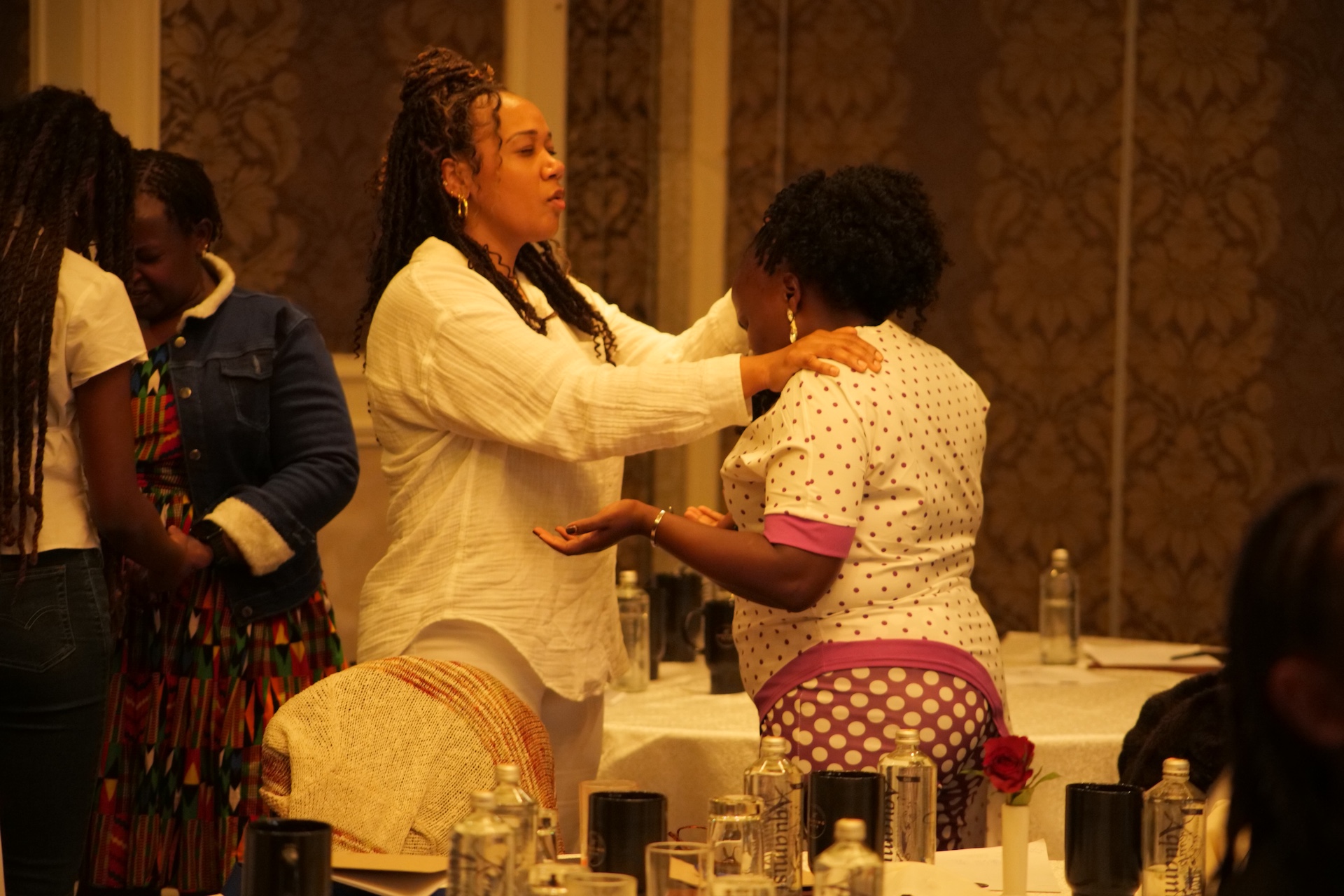 Women gathered in prayer through The Praying Wife